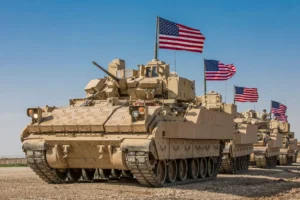 Tanks with American flags in formation.